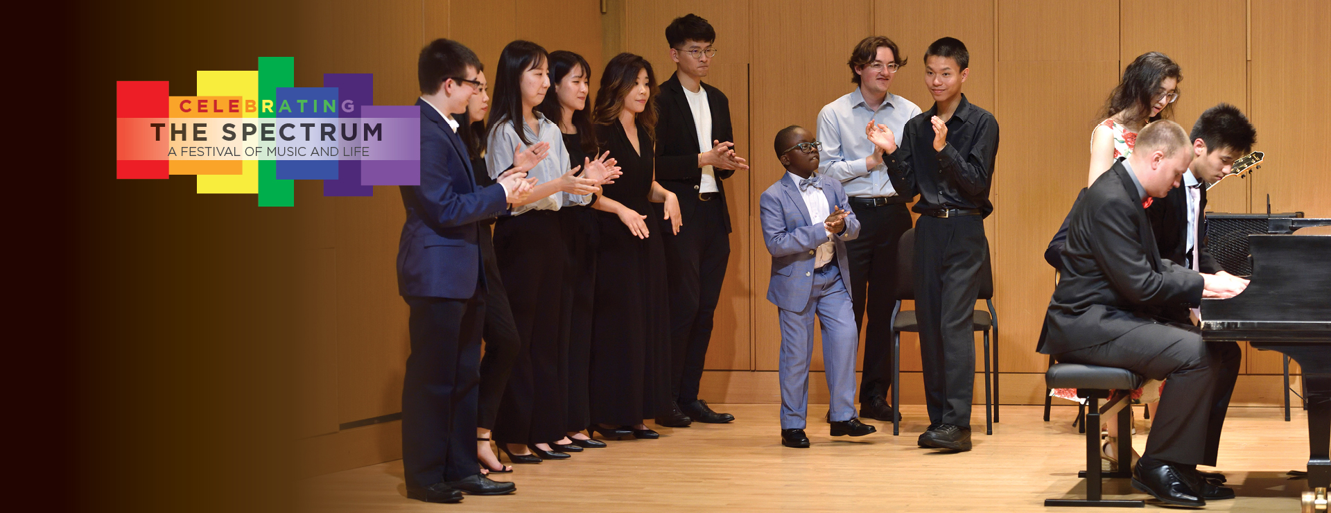 Photo: Musicians performing, and celebrating muisc on stage together. Logo in the upper right, 