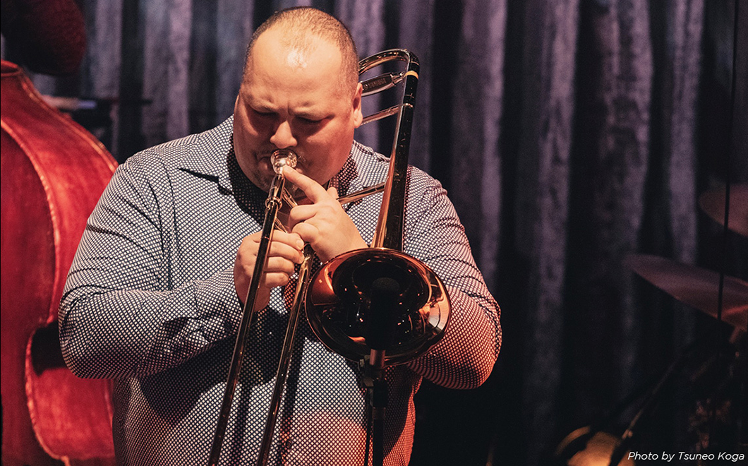a person performs trombone on stage
