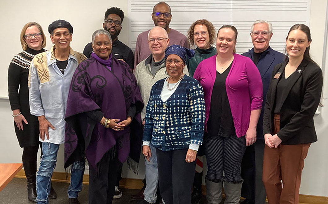 a group of 11 people gathered for a photo