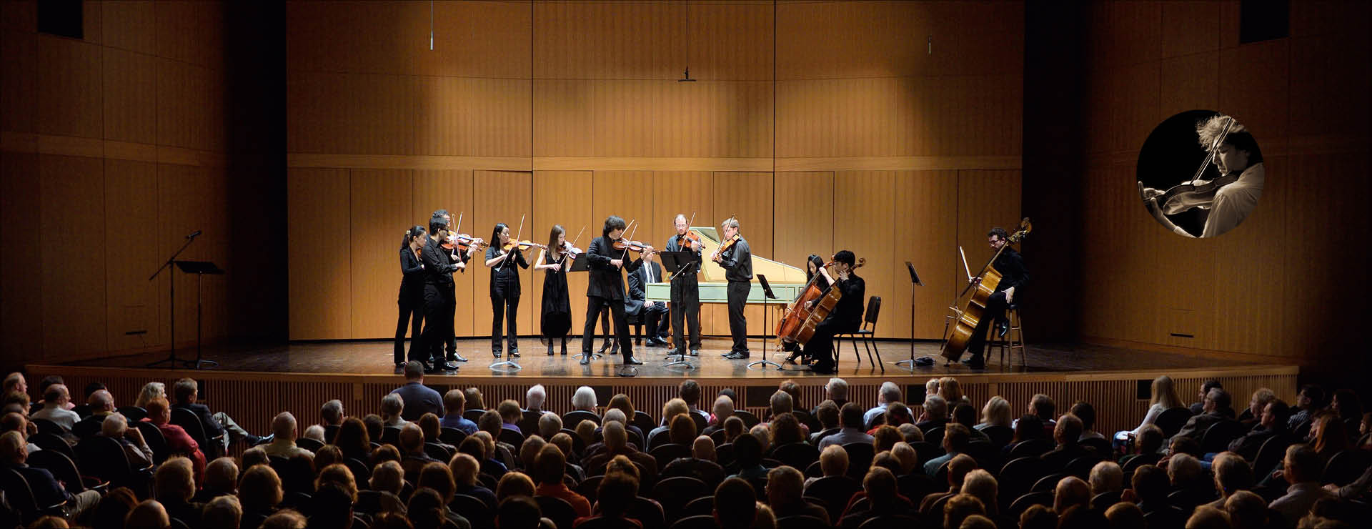 Image of string chamber instrumentalists performing on stage. Inset image of faculty memeber Dmitri Berlinsky in the upper right hand corner.