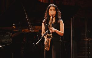 person performing on a saxophone