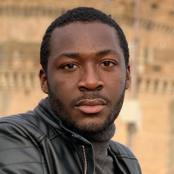 person with dark hair and black leather jacket