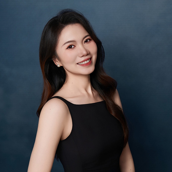 smiling person in black clothing, blue background