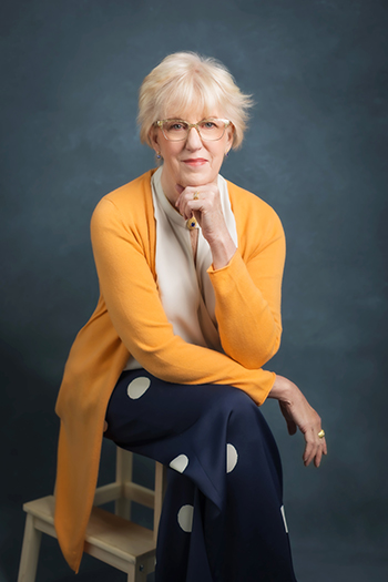 Person seated posed arms on lap and hand under chin