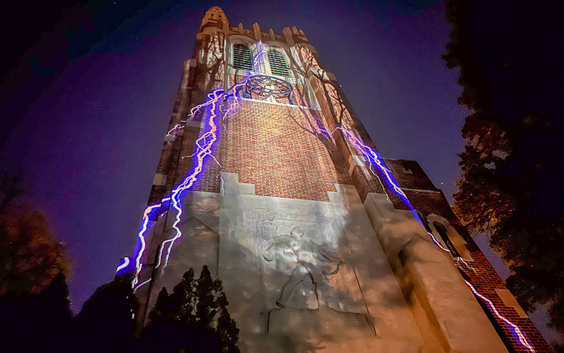 a tower lit up by lights that look like lightning strikes