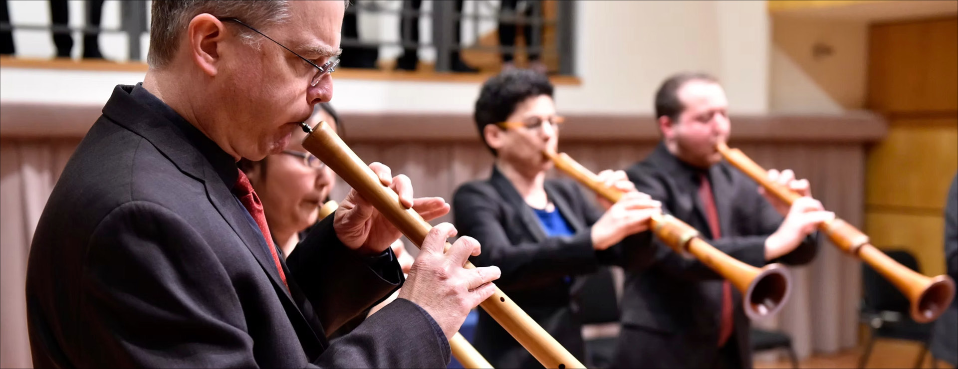 Closeup of early music instrumentalists on stage performing on period instruments