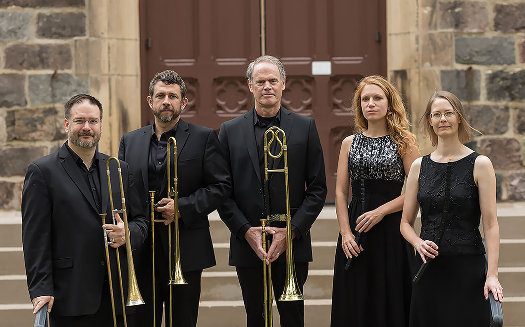 Ensemble members of early music group, Dark Horse Concsort, posing for a picture outside of a church