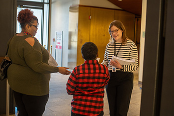 two adults and a child in a lobby of a building