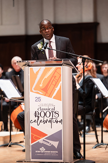 a person on stage speaking at a podium