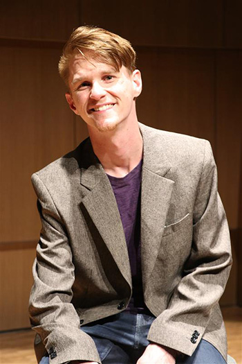 person in sport coat smiling
