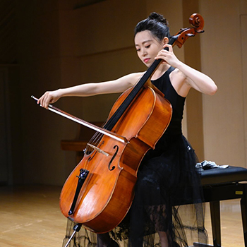 a person plays cello on a stage