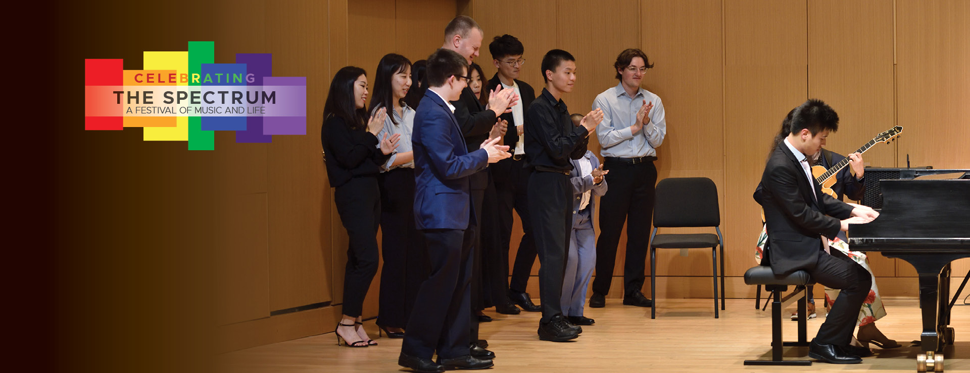 Photo: Musicians performing, and celebrating muisc on stage together. Logo in the upper right, 