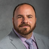 Portrait of Jon Lehr, subtle smile, looking at camera 
