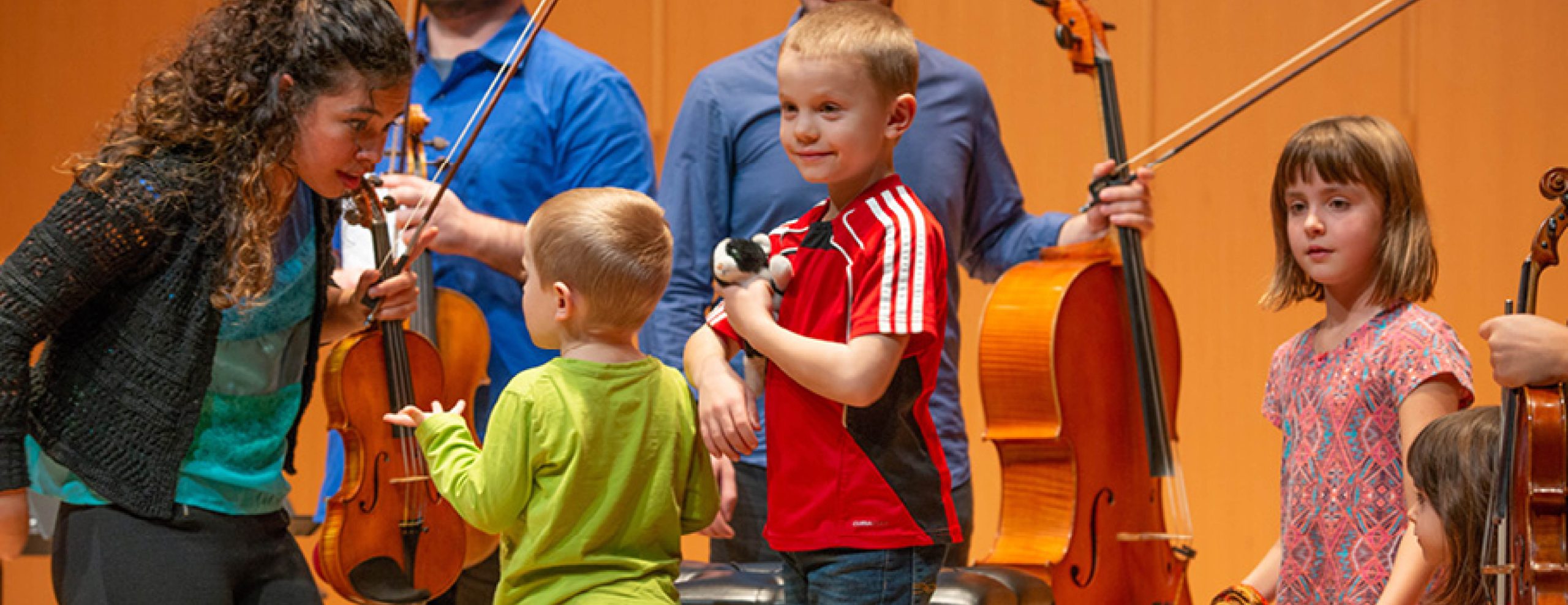 Sensory Friendly Spartan Concert. Musicians and young children on stage together.