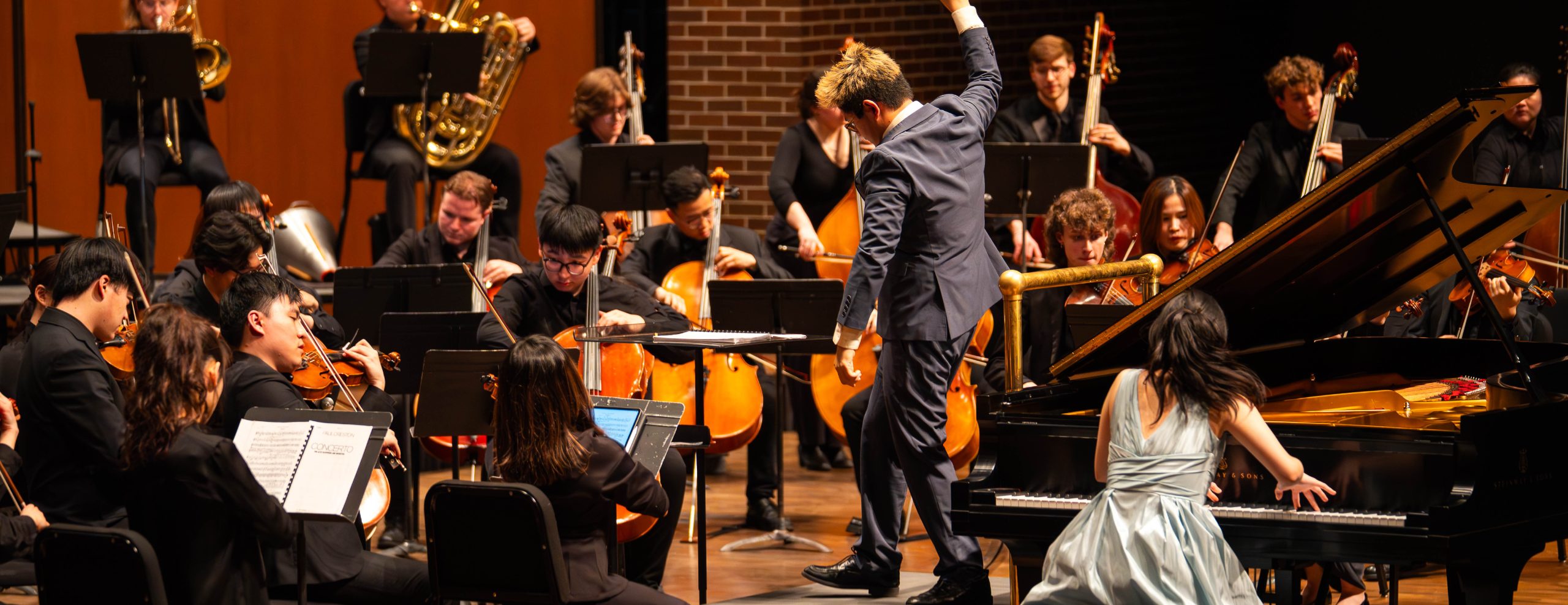 MSU Symphony Orchestra and Honors Students performing on stage.