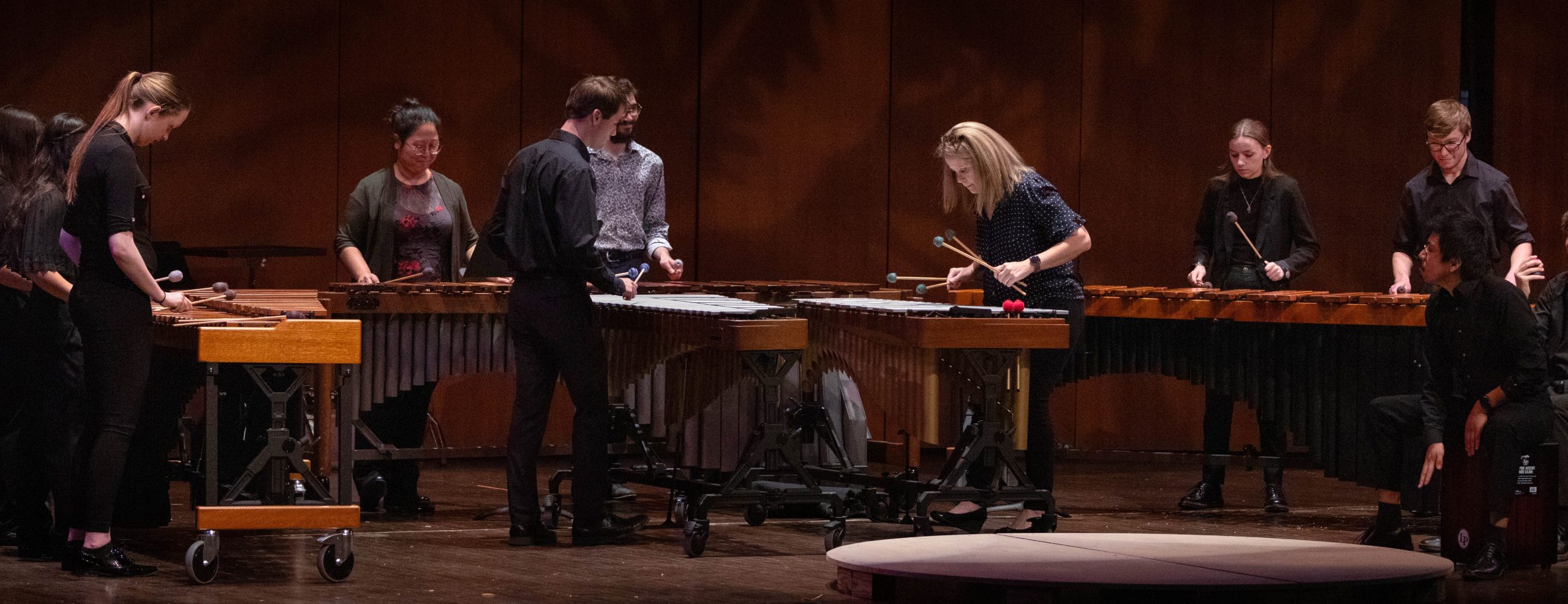Percussion musicians perform on marimbas and vibraphones.