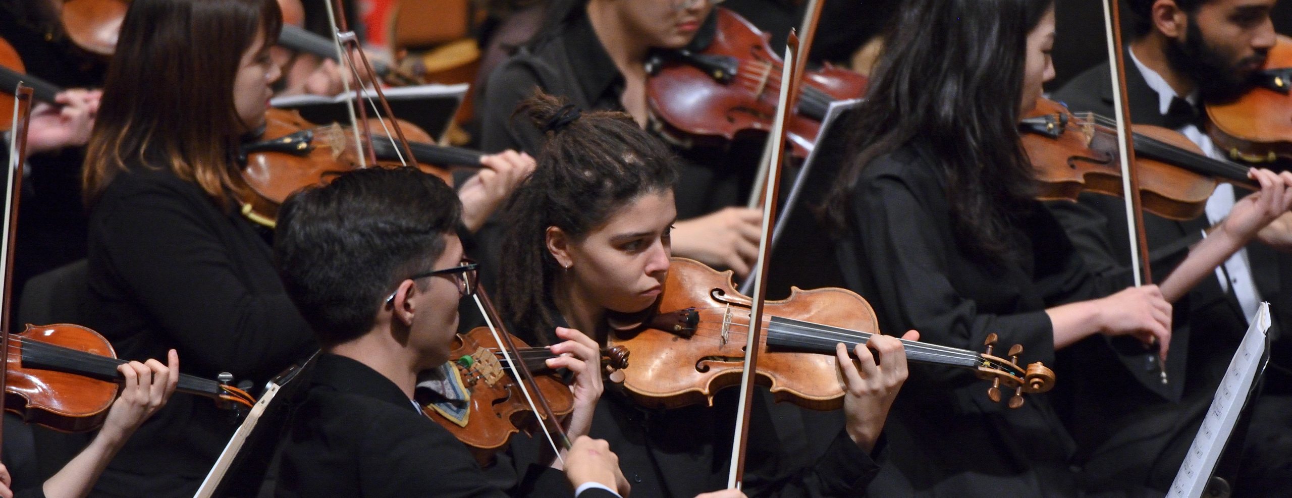 A variety of MSU students playing string instruments on stage.