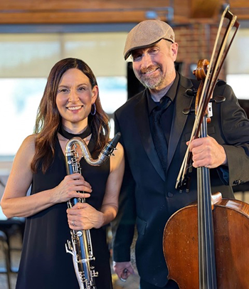 two people holding instruments, one a bass clarinet and the other a cello