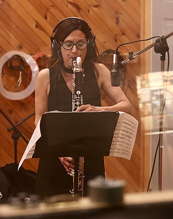 person playing clarinet in a recording studio