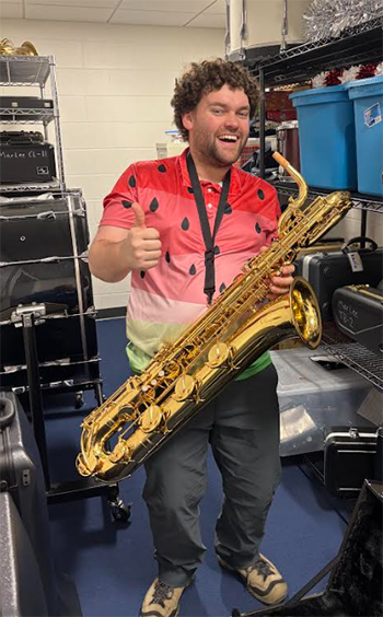 a person in a colorful shirt holding a saxophone
