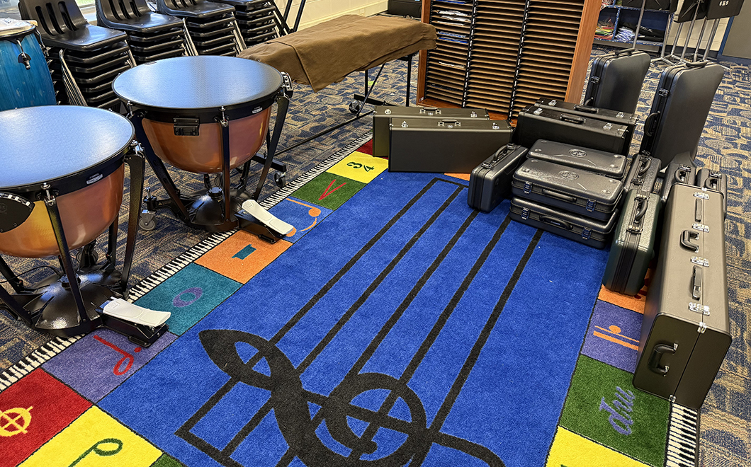 a music classroom with instruments and a colorful carpet