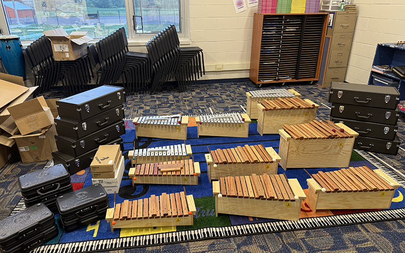 several musical instruments on the floor of a classroom
