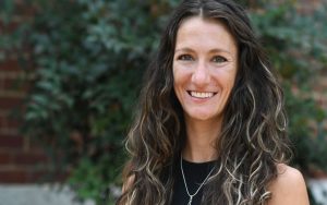 Photo portrait of visiting professor, smiling and looking at camera in an outdoor setting, Kelli Smith-Biwer, from University of Michigan